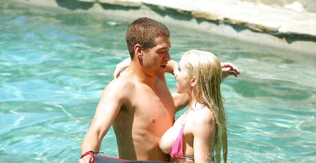 Sultry american blonde Christie Stevens exhibiting big tits and sexy ass at pool